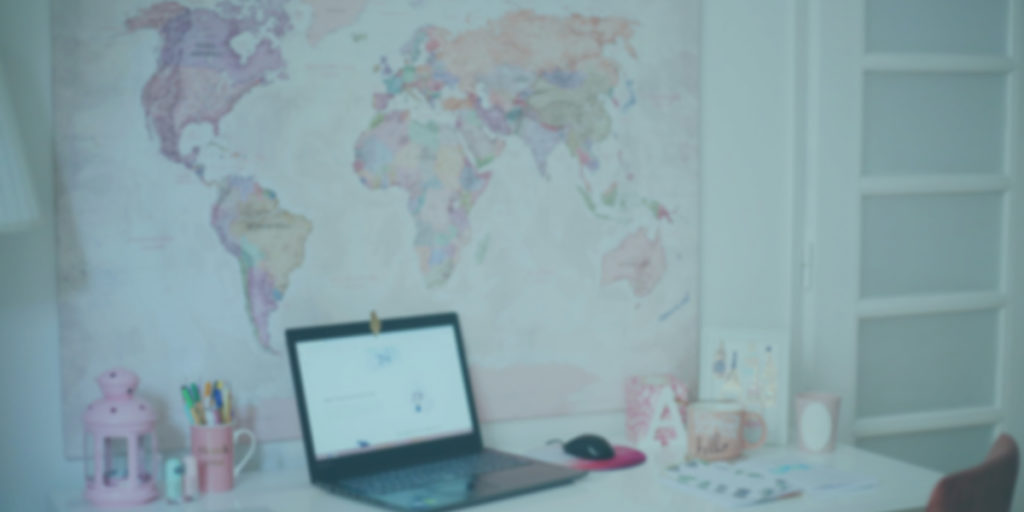 A laptop with a map of world cities in the background represents the global reach of remote work.